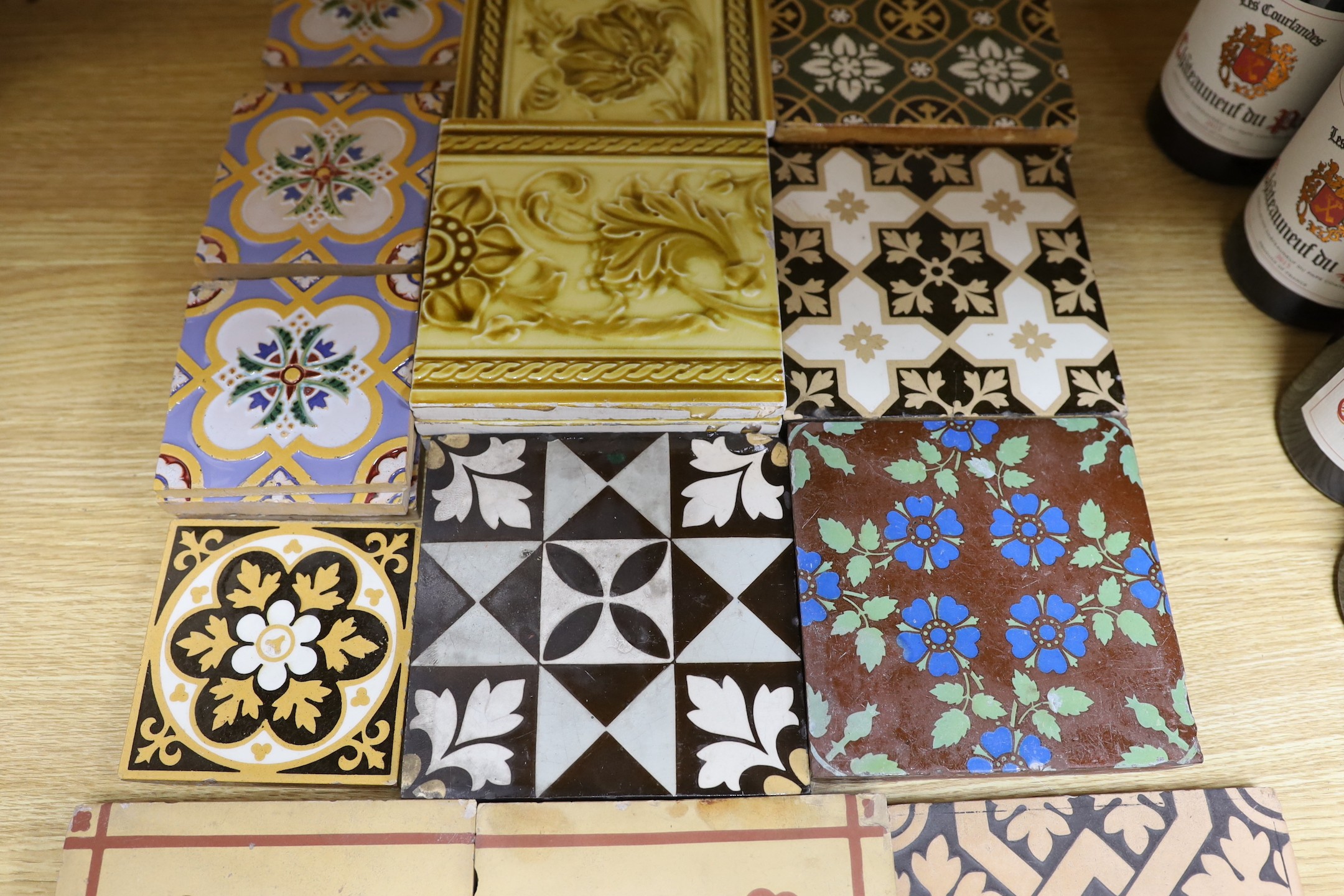 A selection of 19th and 20th century tiles, including Minton encaustic and W. Godwin tiles